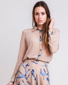 Woman wearing a printed classic fit silk shirt in beige